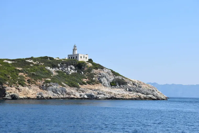 A lighthouse on a rocky islet
