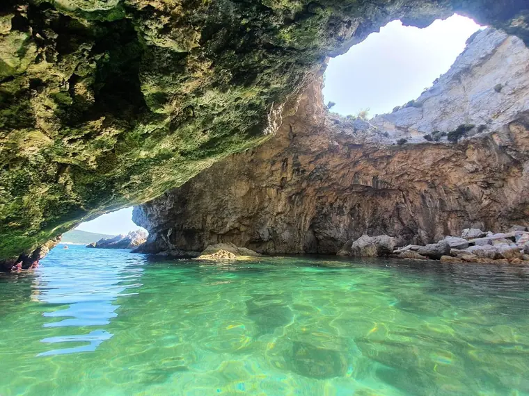 Emerald water under a sea cave arch