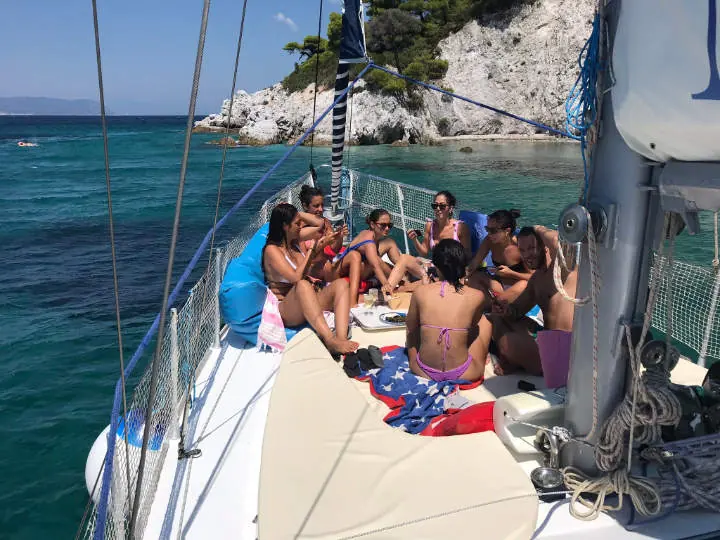 Guests on the foredeck at anchor