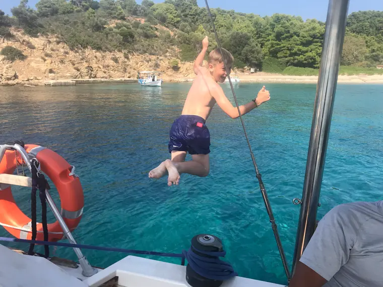 Jumping off the boat into turquoise water