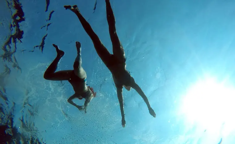 Two swimmers seen from underwater
